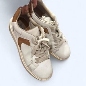 Cream and white Steve Madden golf sneakers